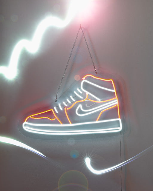 Neon Nike Air Jordan 1 shoes LED sign in red and white hanging on a wall